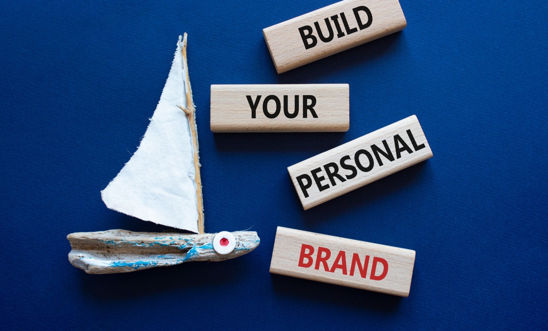 Blue background with wooden blocks saying build your personal brand 