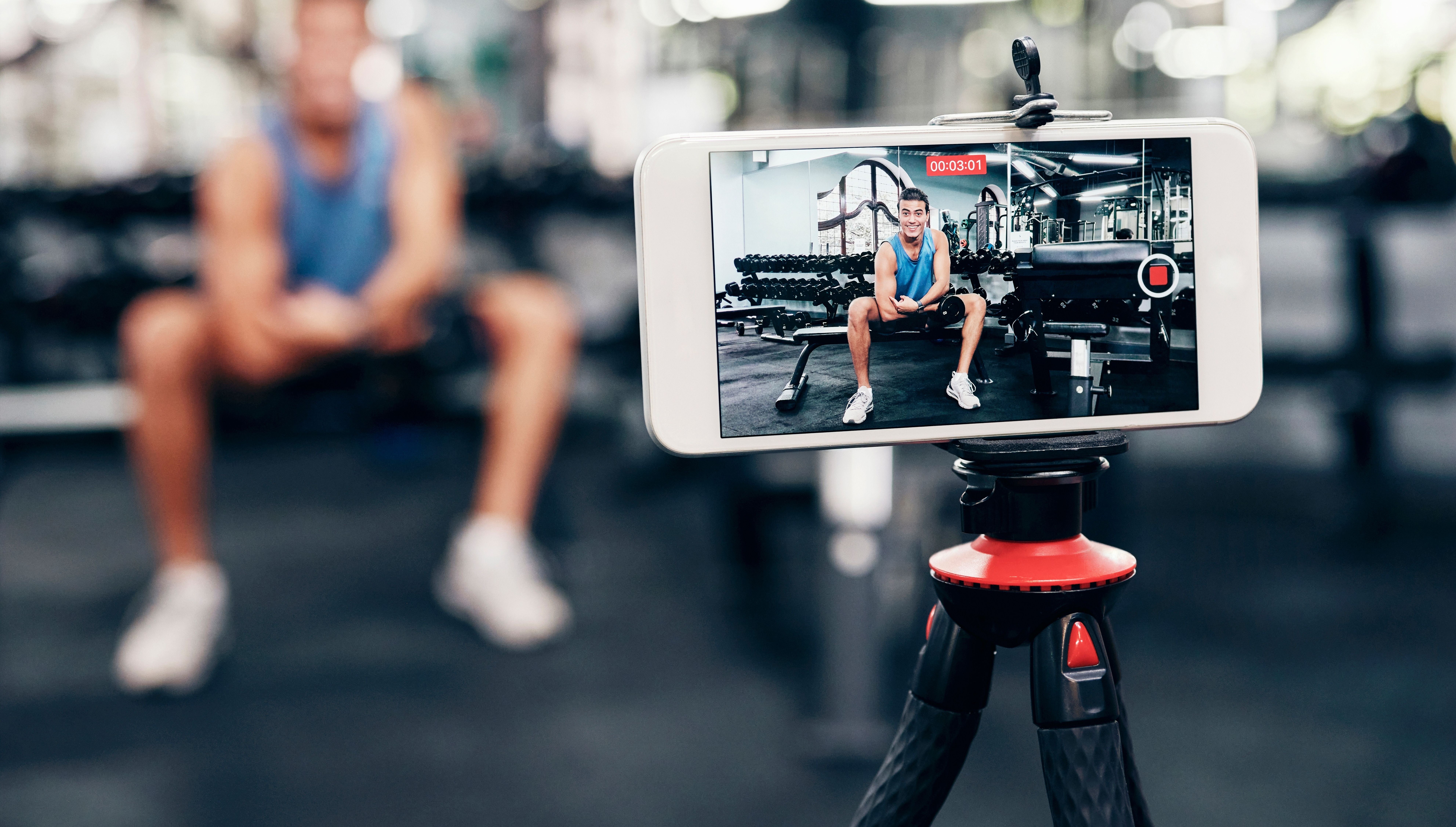 Man talking to his phone camera recording some classes that he will sell online 