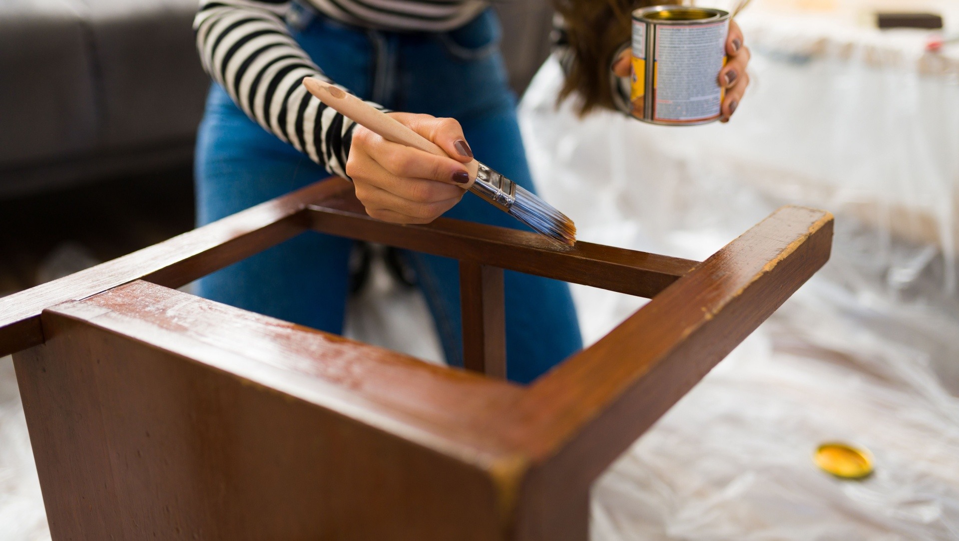 Woman painting furniture to flip for a profit