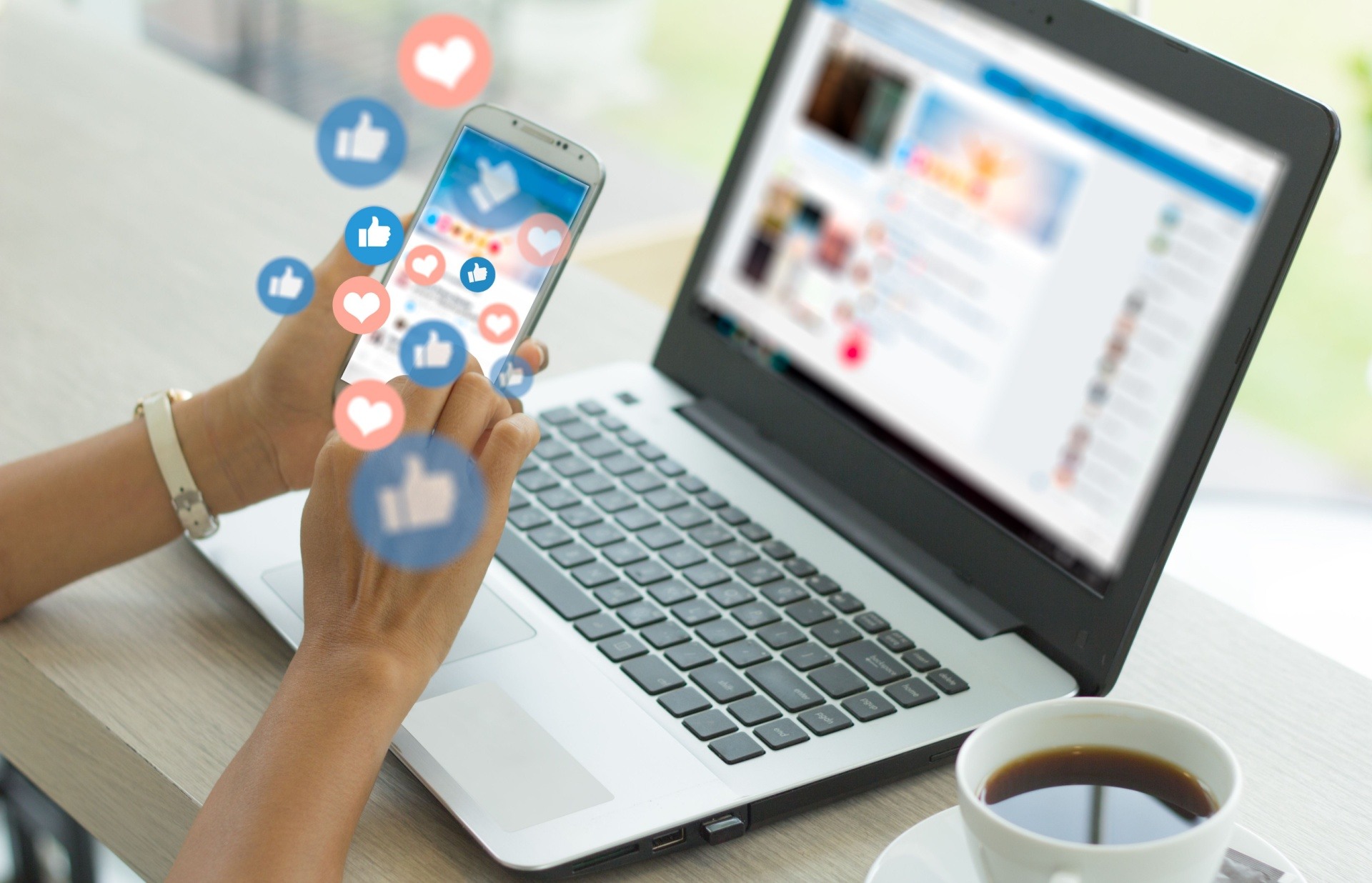 Social media graphic with women holding her phone in front of a lap top 