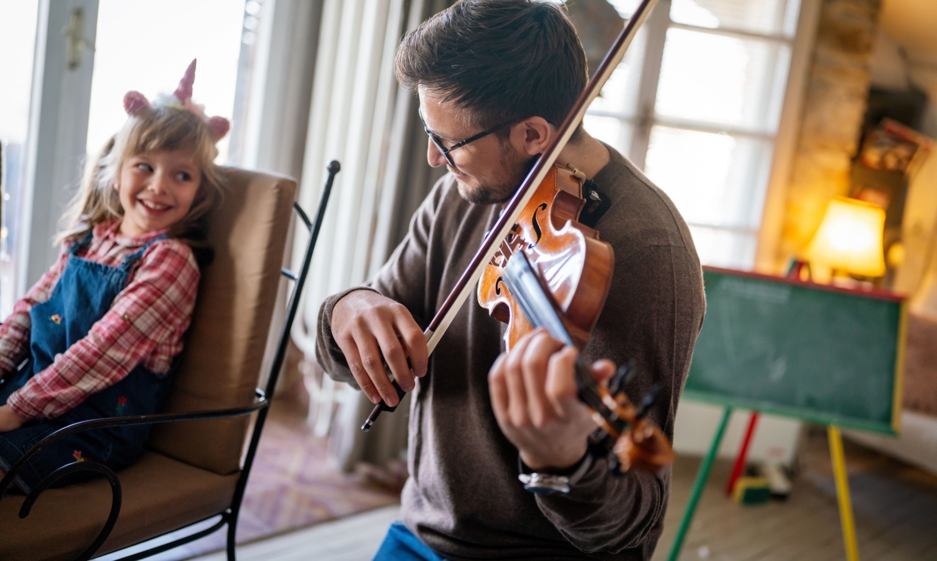 Adult teaching child the violin