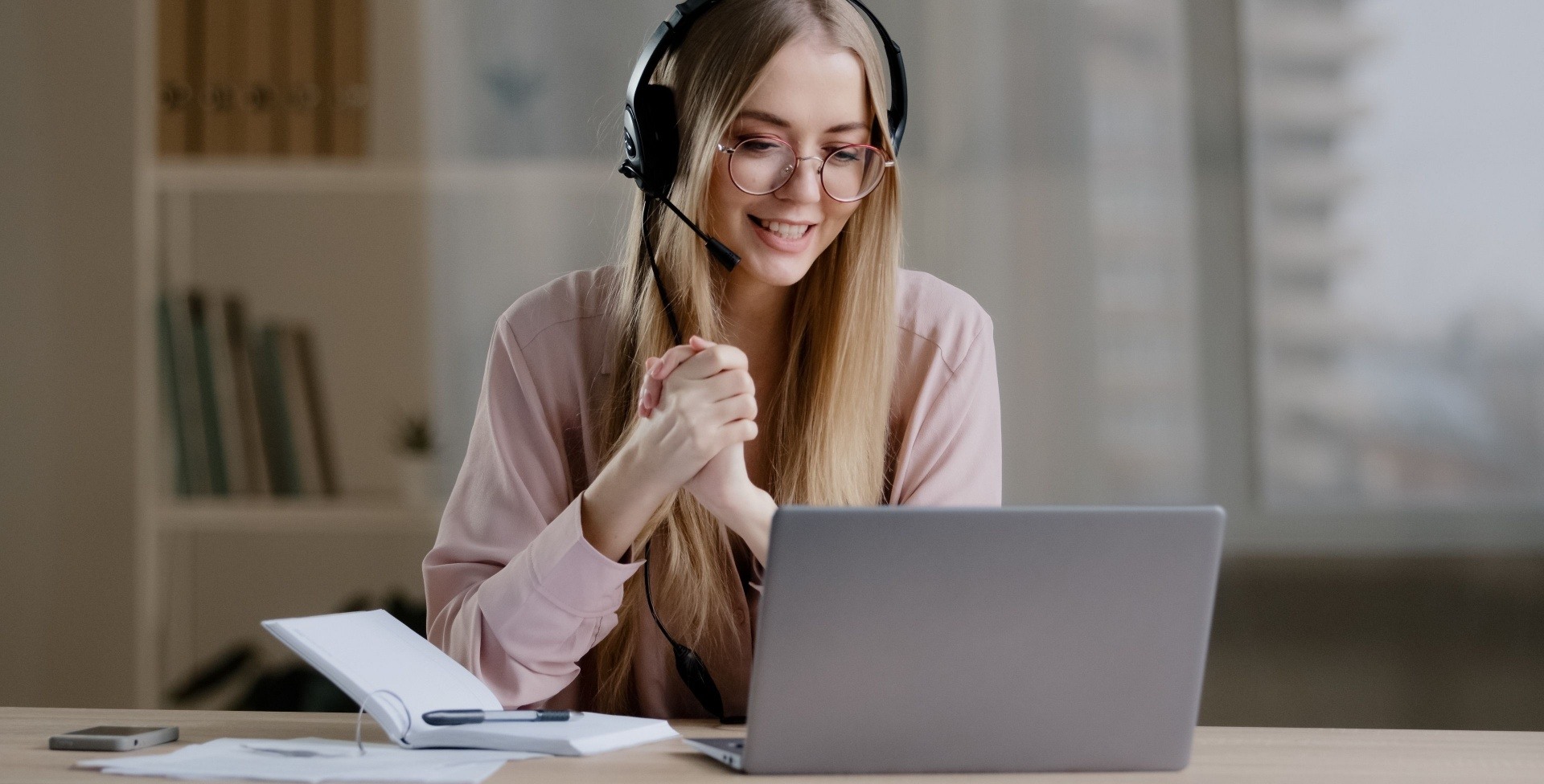 Woman with a headset on giving some online mentoring 