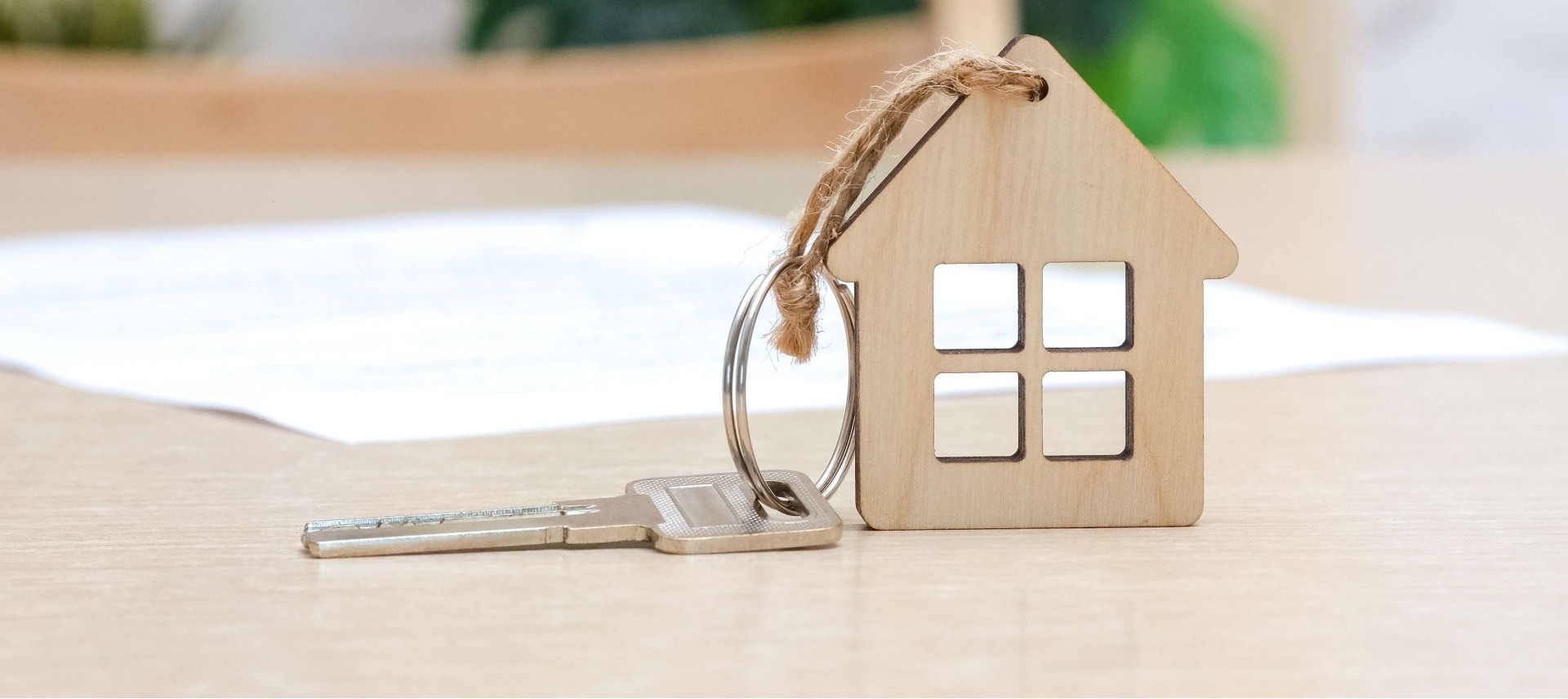 Wooden house with a key attached to it 