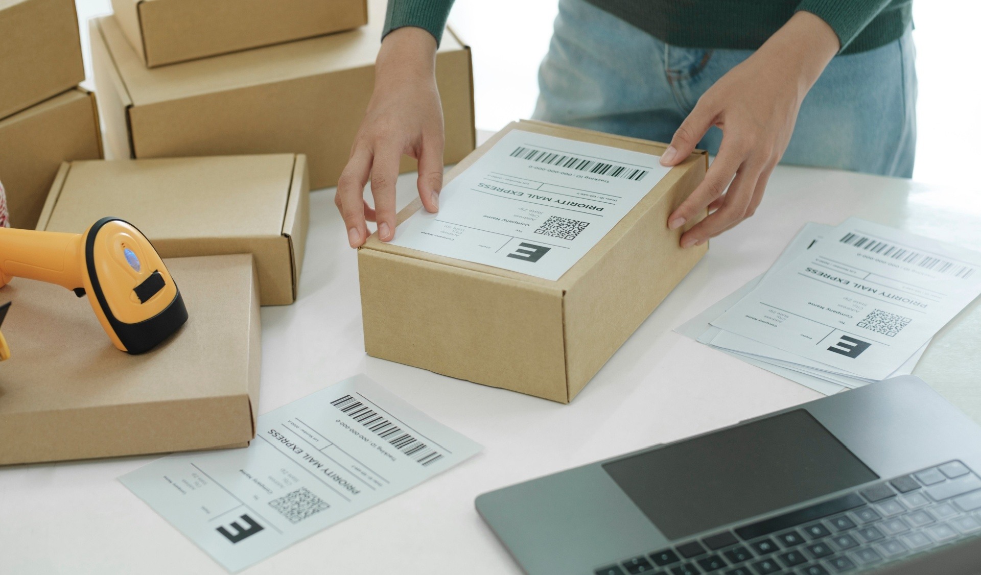 A man placing a label on top of a wooden package 