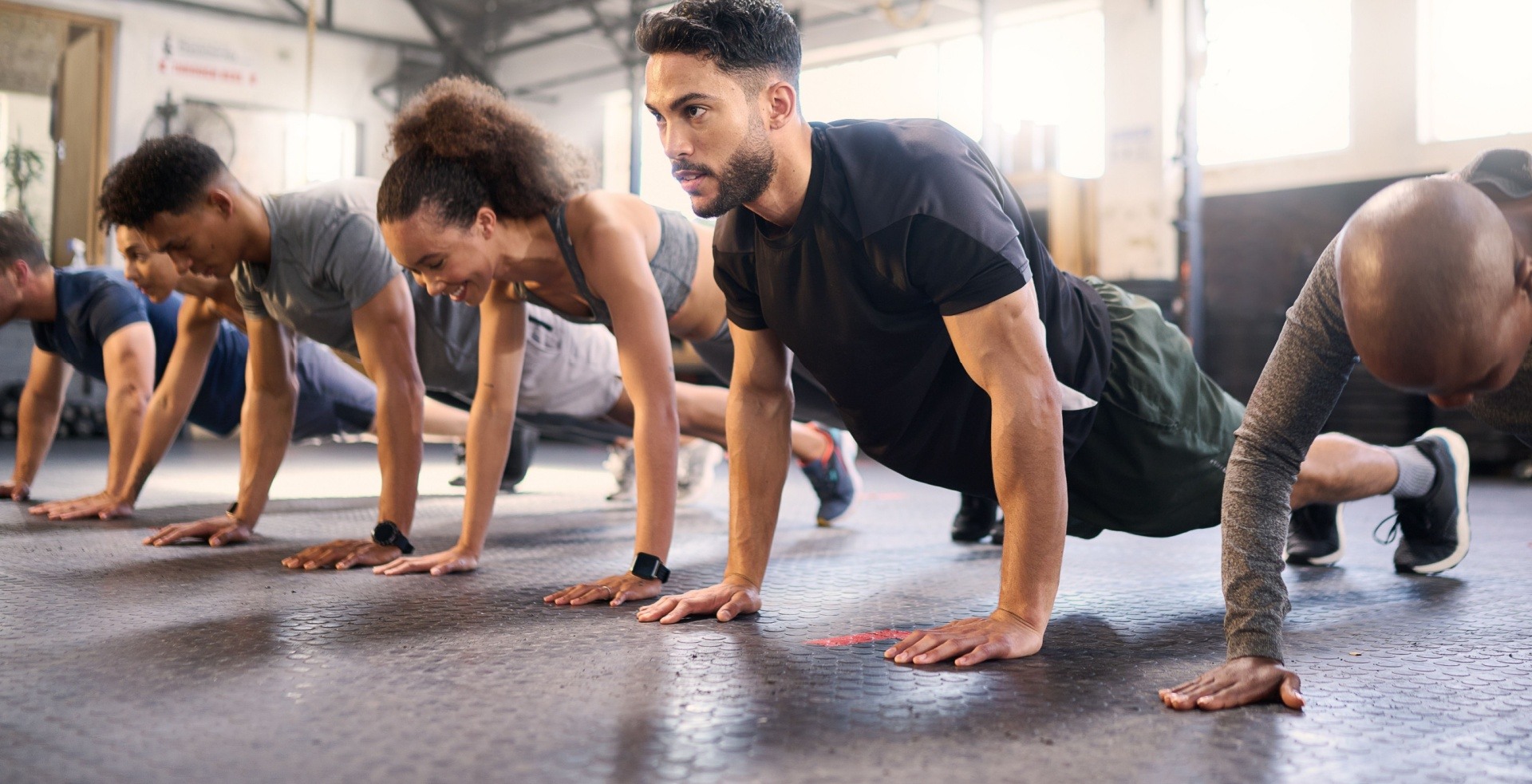 Lots of people doing a fitness class together filming and selling it online