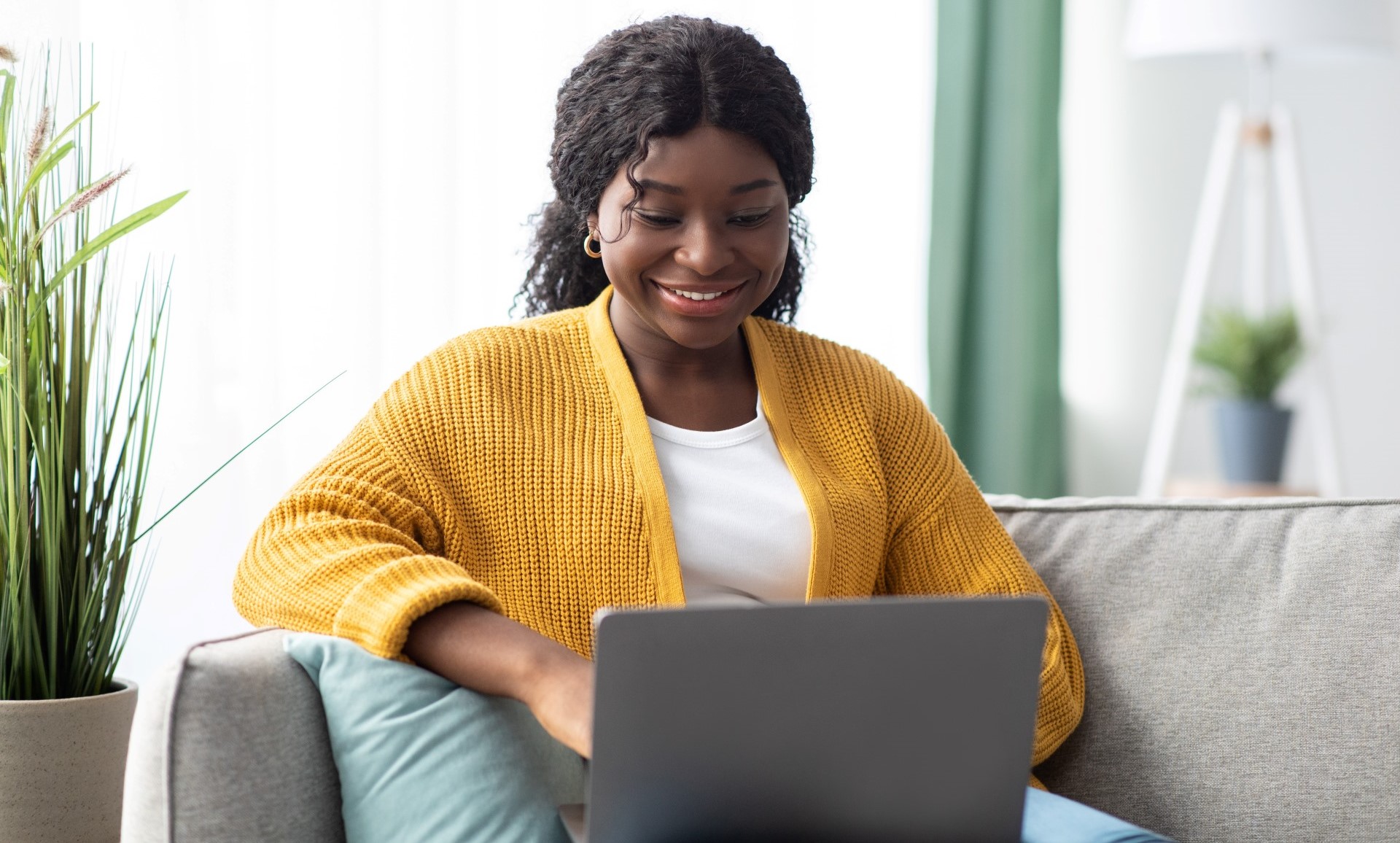 woman sitting on chair and typing on laptop