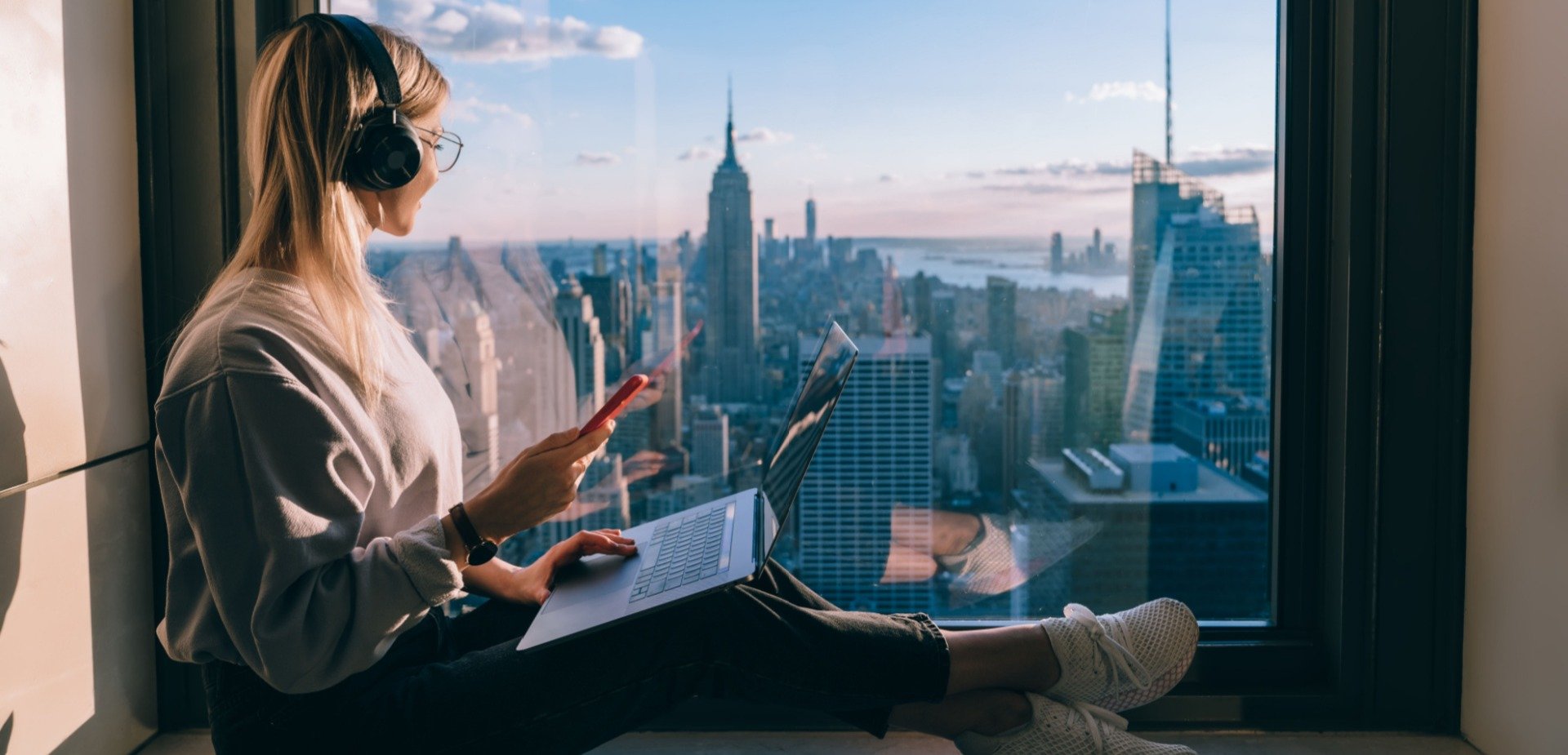 Freelancer woman making money remotely from her skyscraper apartment