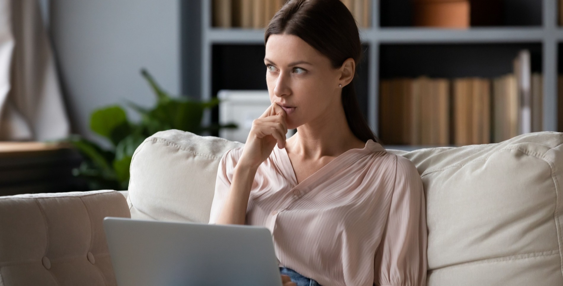 Woman with dark brown hair on her laptop gambling 