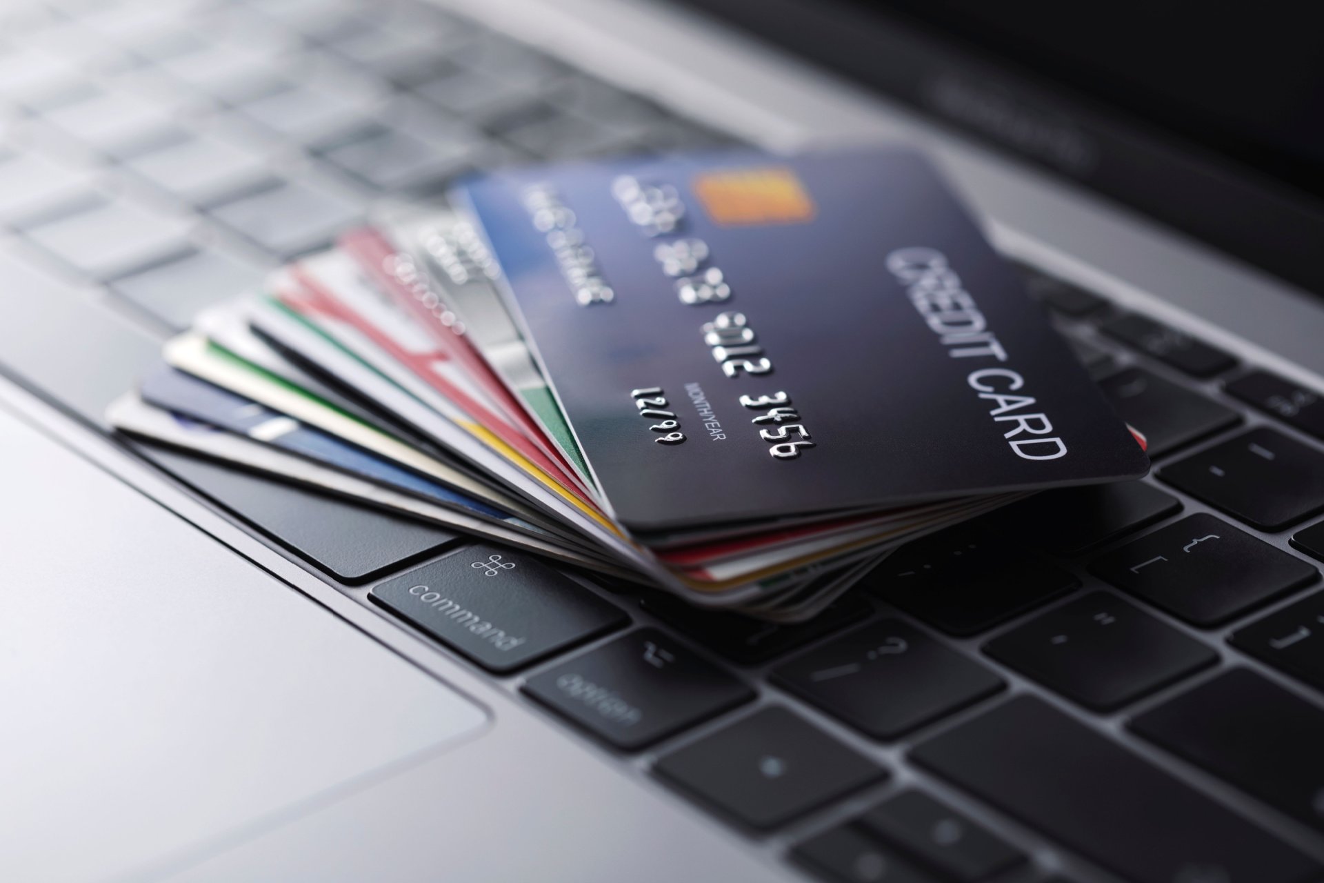 Credit card stack laying on a laptop keyboard