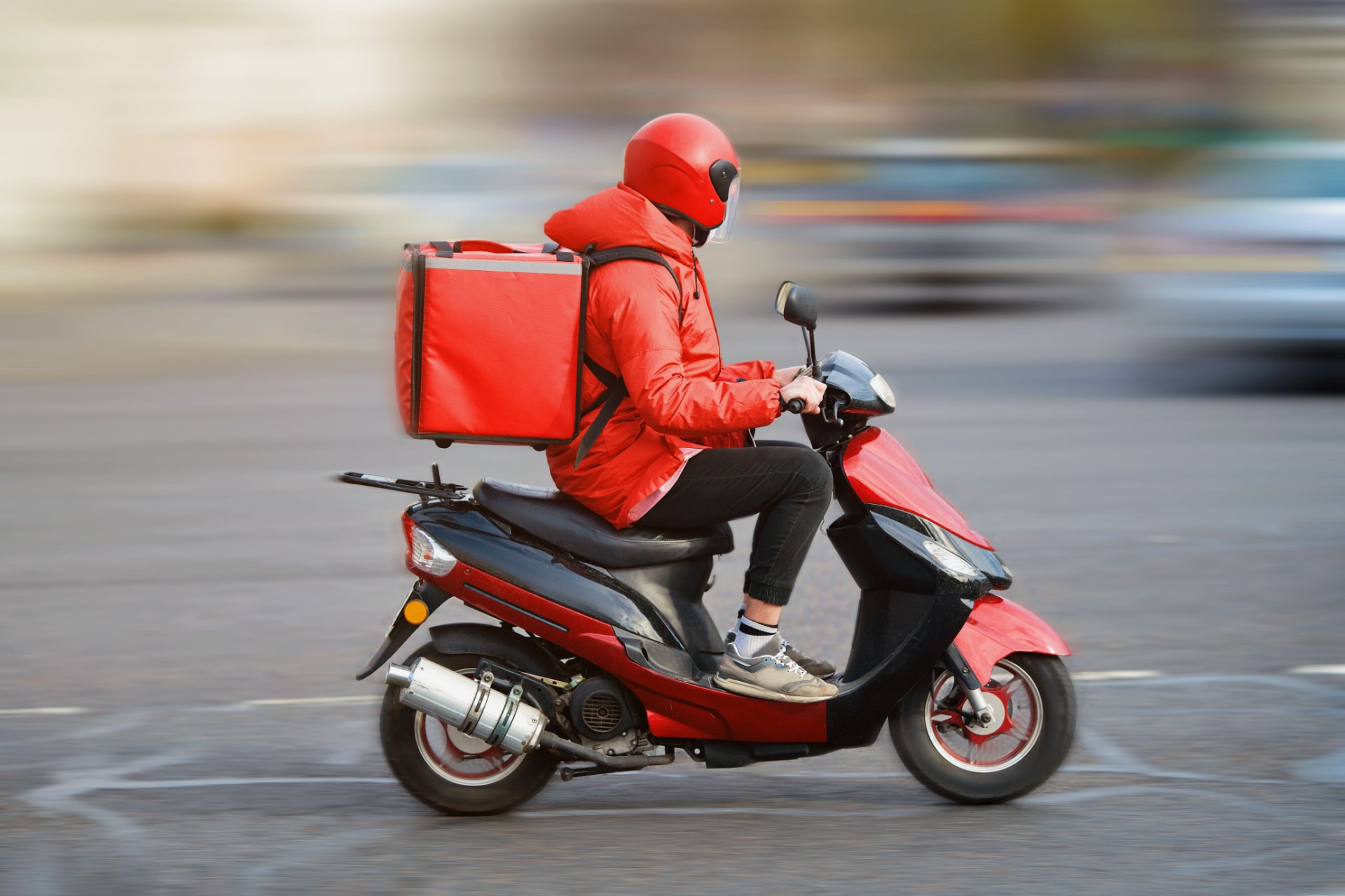 Food delivery driver delivering food on his moped