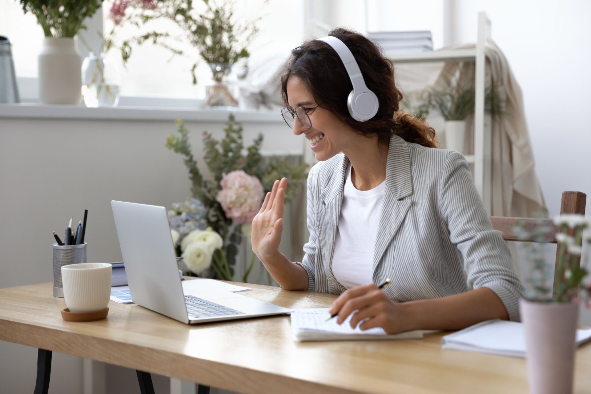 Virtual assistant woman smiling and waving at her client