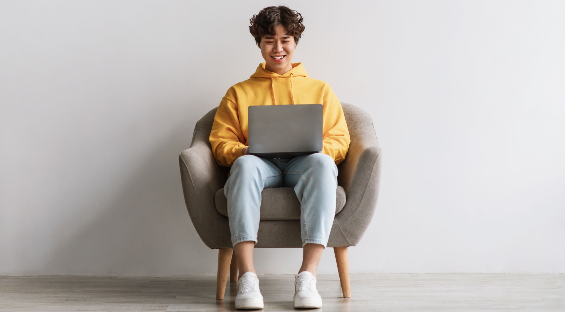 Man on his armchair converting free bets on his laptop