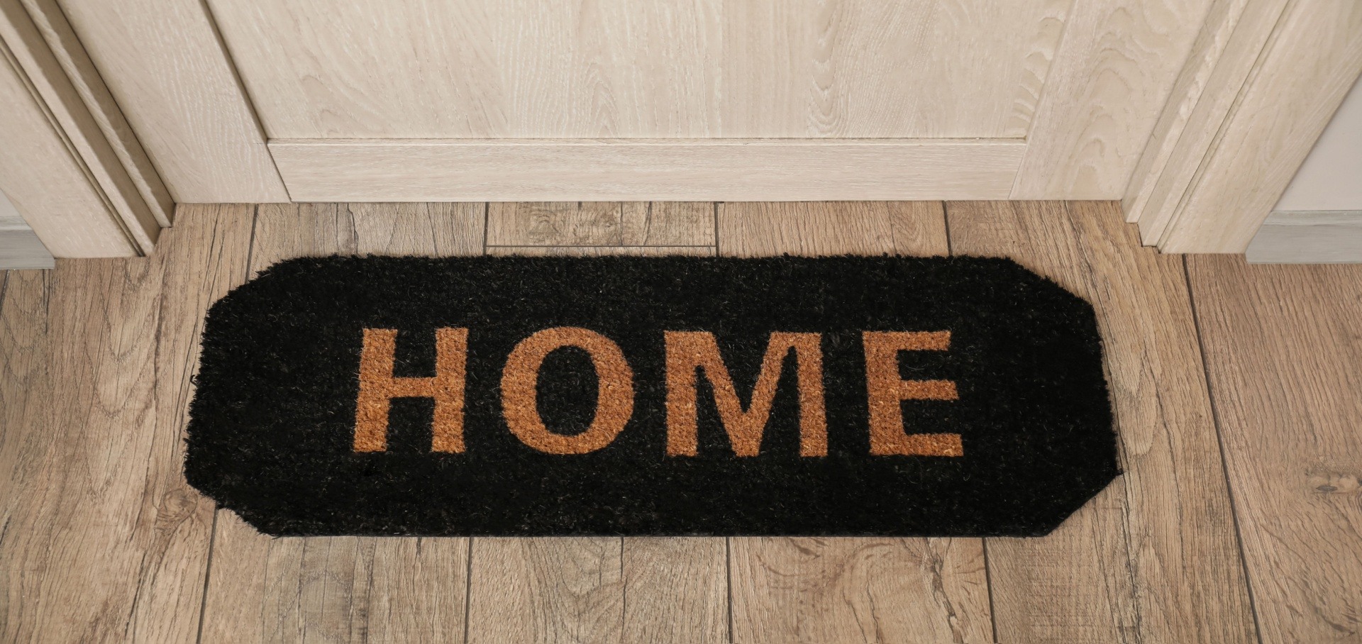 Welcome mat with Home written on it