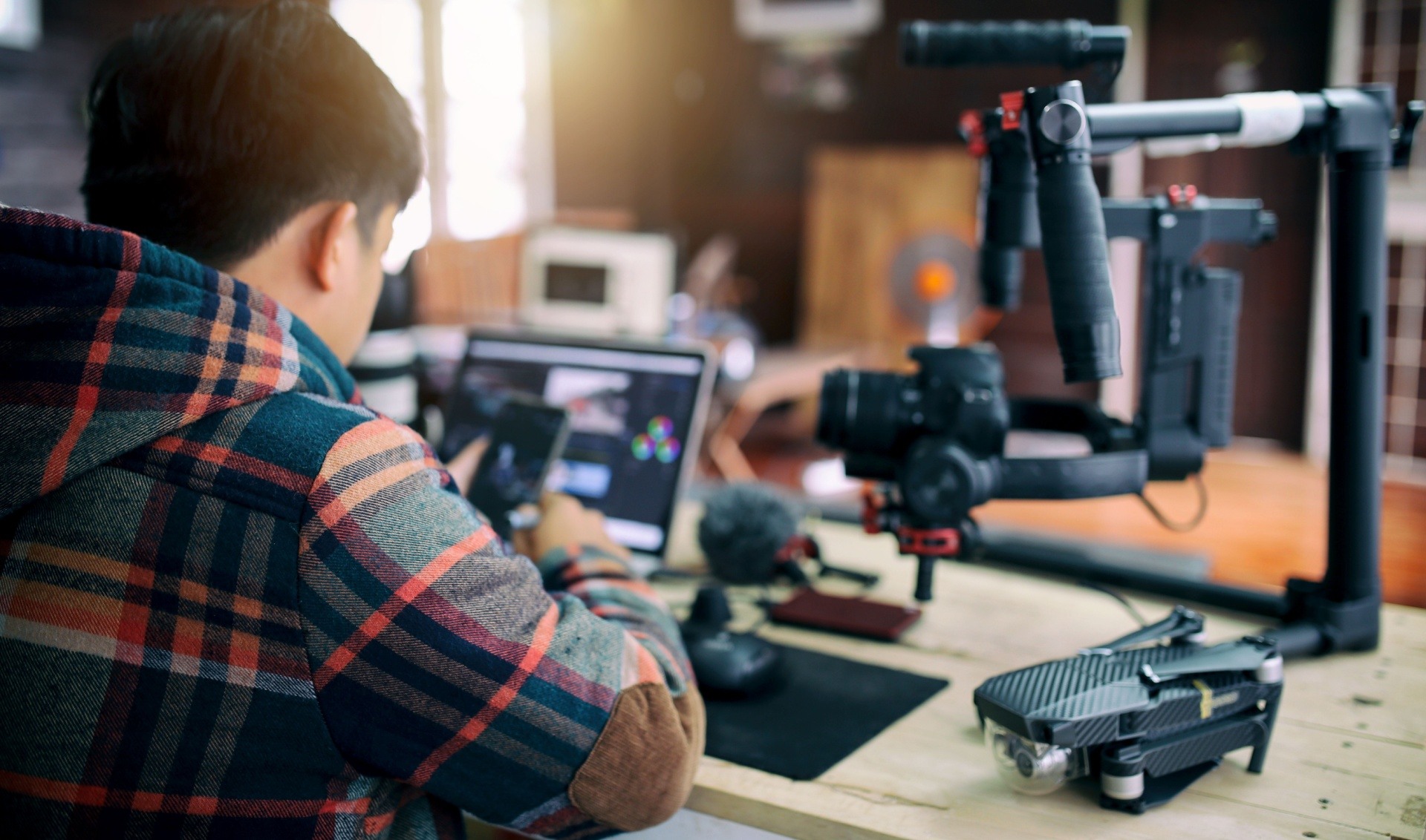 A young boy doing some video production to make money online 