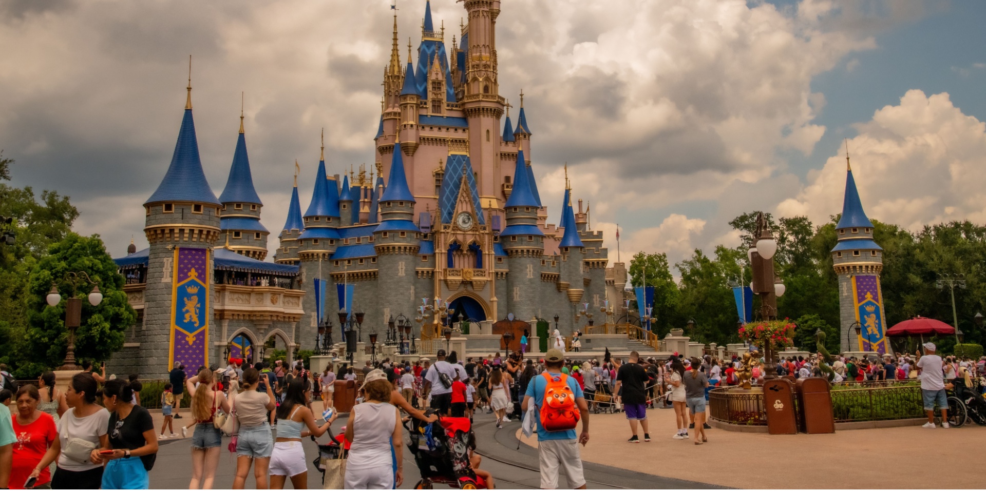 Disney world castle with people in the foreground