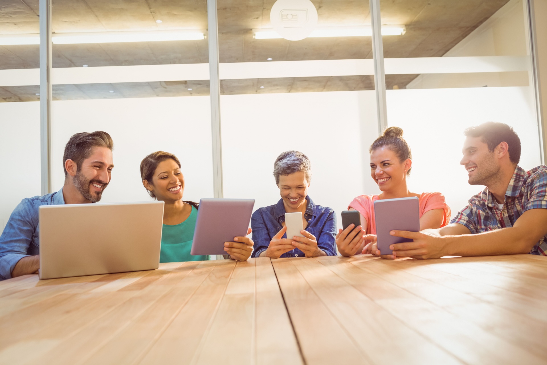 Group of people on laptops having fun.