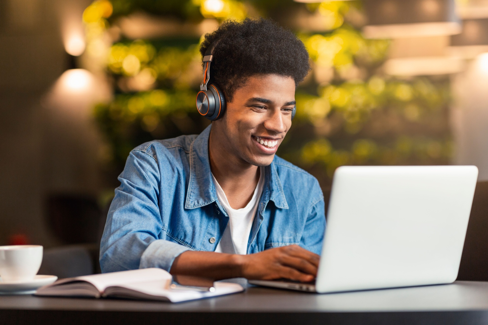 Young man on laptop smiling 