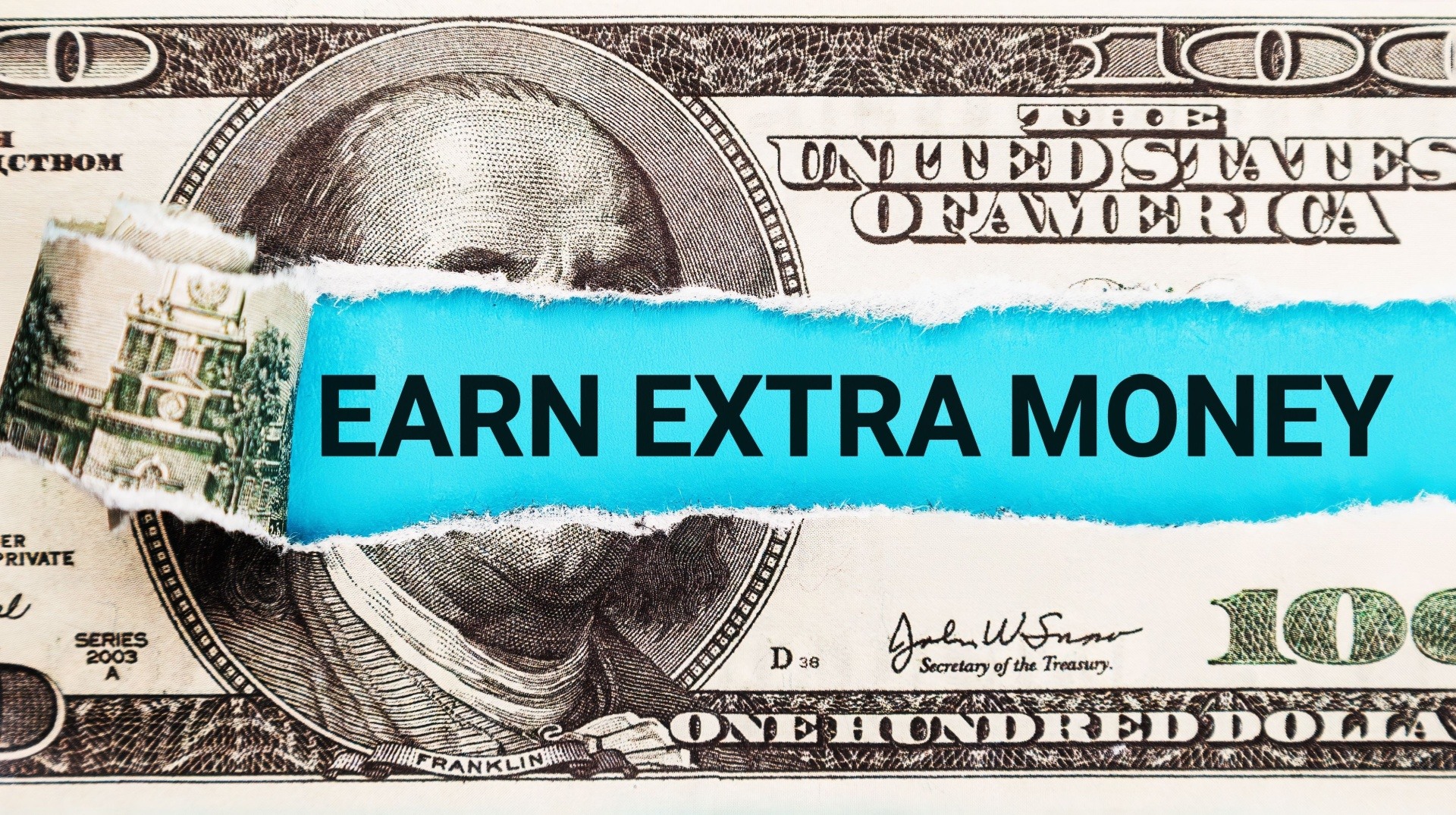 money with tear in it saying earn extra money. It is also a $ bill